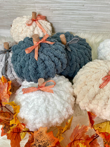 A pile of chunky knit pumpkins