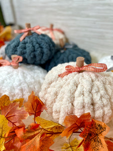 A pile of chunky knit pumpkins