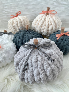 A pile of chunky knit pumpkins